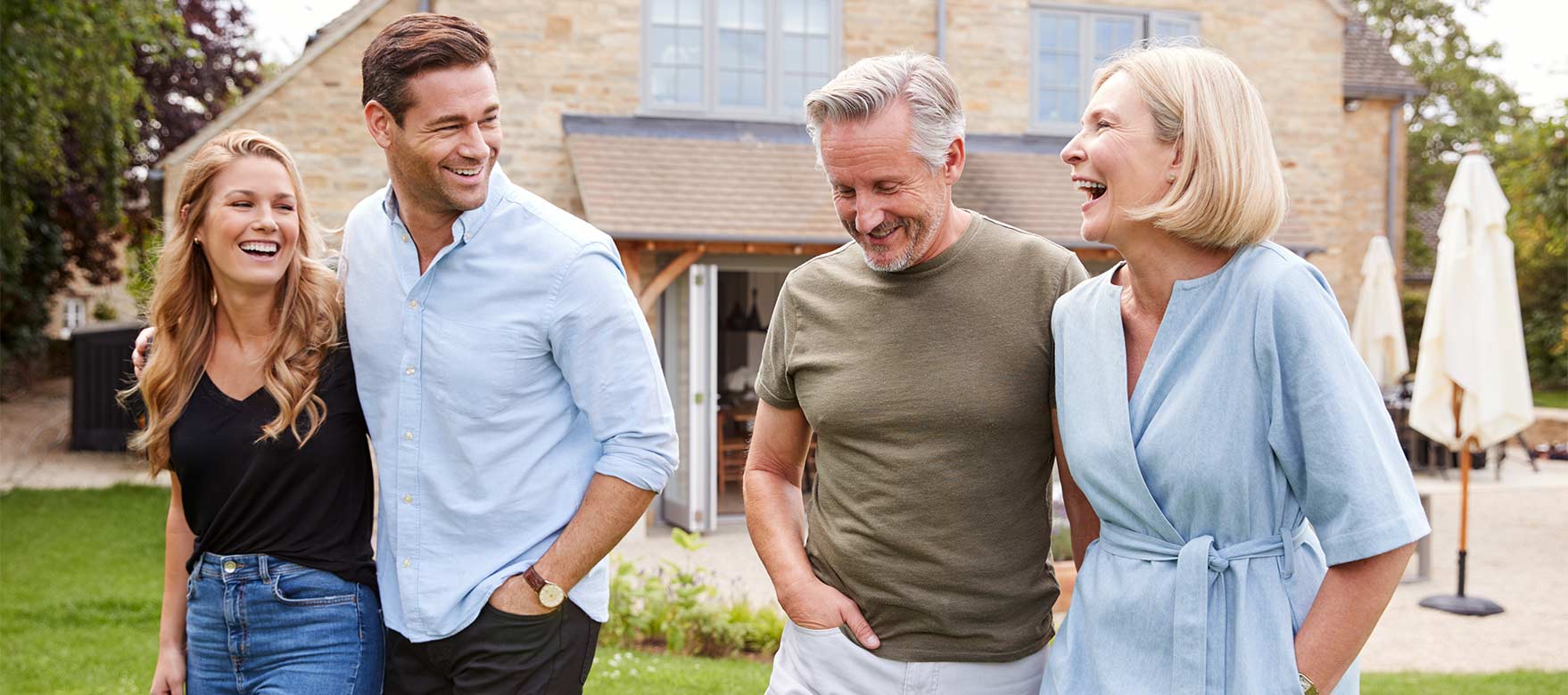 Military family standing in front of house